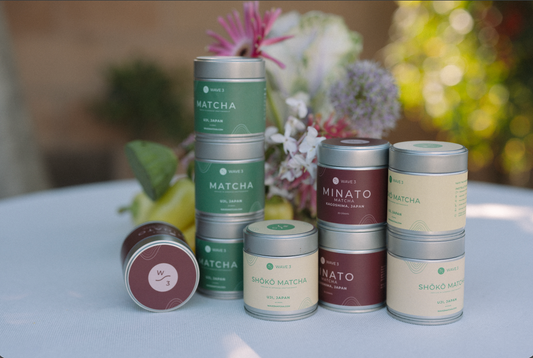 3 types of matcha tins stacked. Wave 3, Shoko and Minato on a table